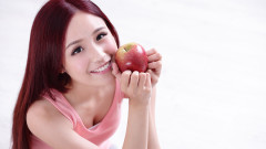 Health girl show Apple with smile face health food concept asian woman beauty